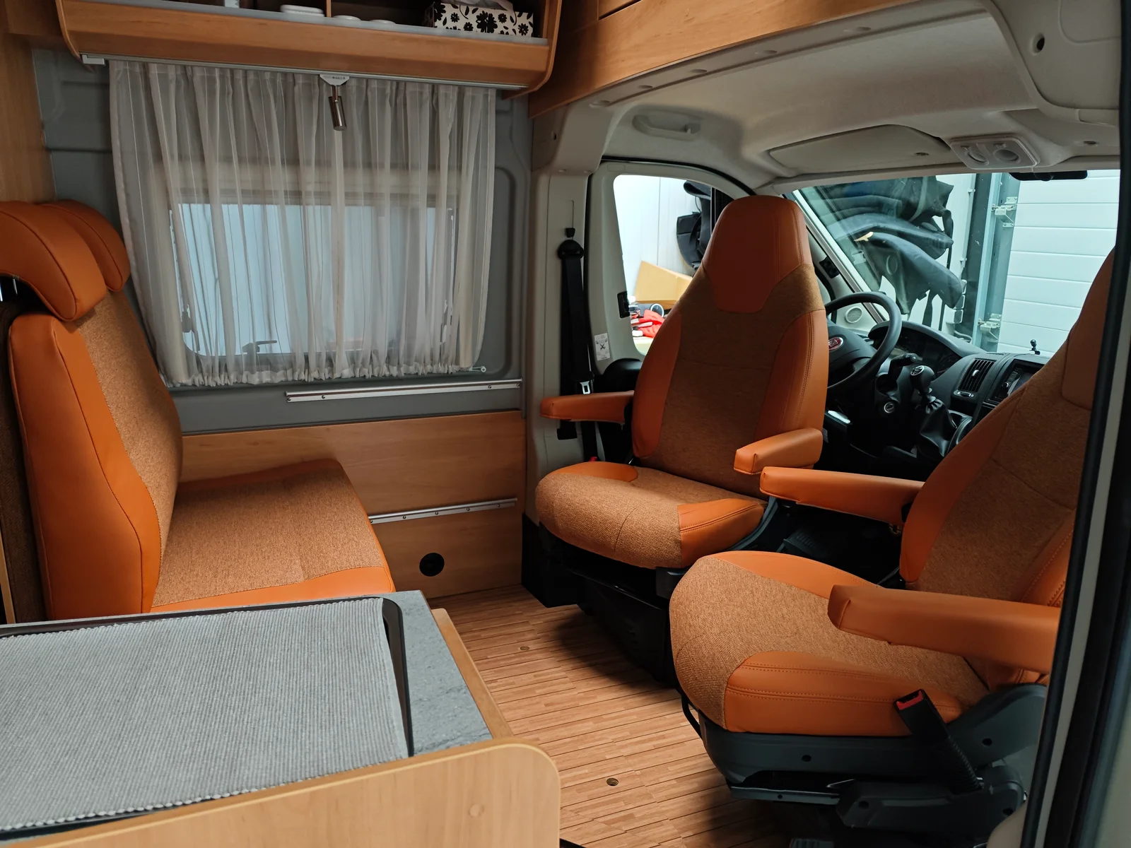 Camperinterieur met oranje voorstoelen